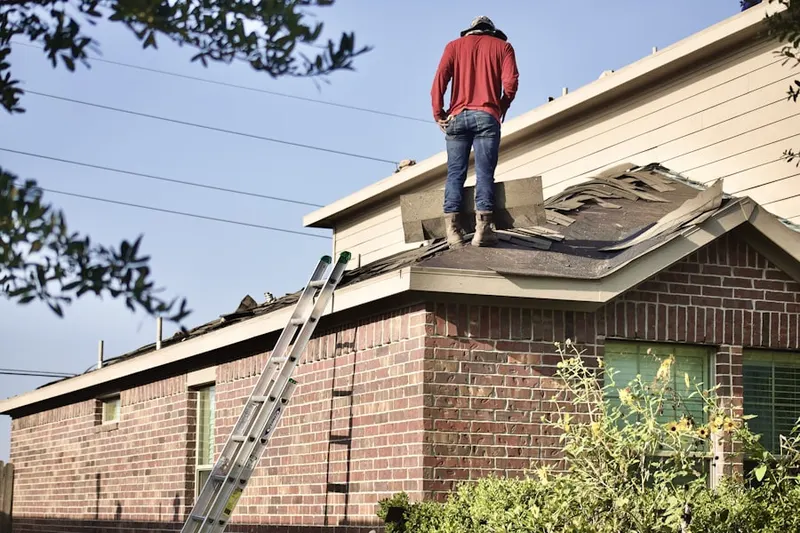 Professional roofer working on a residential roof in Agate